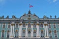 Sunny day in Saint-Petersburg, russian flag flying above facade of Hermitage State Museum Royalty Free Stock Photo