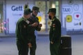 Three boys in military uniforms and masks are standing Smoking and talking at the entrance to the Pulkovo terminal