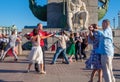 Happy adults are dancing tango or waltz on the city street