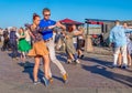 Happy adults are dancing tango or waltz on the city street