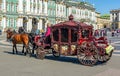 Saint Petersburg, Russia - August 2019: Horse carriage on Palace square and Hermitage museum at background Royalty Free Stock Photo