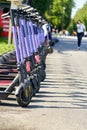 Rental electric scooters in a shared parking lot in the city park