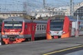 Two suburban electric trains on the Baltiyskiy railway station on a sunny summer day Royalty Free Stock Photo