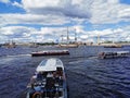 Boats and yachts with tourists sail to the Neva to see warships and sailboats for the Day of