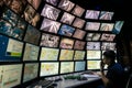 Saint Petersburg, Russia - December 9, 2019: Rear view of man looking at multiple computer screens. Monitoring displays