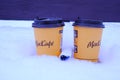 group of yellow-orange takeaway paper cups with plastic brown lid from McDonald`s