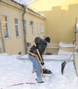 A man from the communal service clears the roof of the snow