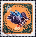 Saint Petersburg, Russia - February 06, 2020: Postage stamp issued in Mongolia with the image of the Camel and pony ride, circa