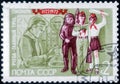 Saint Petersburg, Russia - February 20, 2020: Postage stamp issued in the Soviet Union with the image of Pioneers at reading and