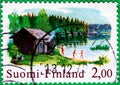 Saint Petersburg, Russia - February 01, 2020: Postage stamps issued in the Finland with the image of the Sauna And The Lake, circa