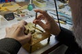 Watch restoration workshop of the state hermitage. Restorer at work repairs gears, watchmaker tools on the table