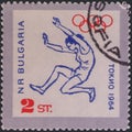 Saint Petersburg, Russia - January 08, 2020: Postage stamp issued in Bulgaria with the image of Long jumper, circa 1964