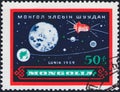 Saint Petersburg, Russia - January 03, 2020: Postage stamp issued in Mongolia with the image of the Lunik 3 with path around moon