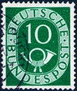 Saint Petersburg, Russia - January 26, 2020: Stamp issued in the Germany with the image of Digits with Posthorn, circa 1951