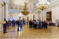 Tourists in the Field Marshals` Room of State Hermitage Museum. Saint Petersburg. Russia