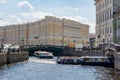 Saint Petersburg, Russia - June 2021: Boats sailing along Moyka river with General Staff at background