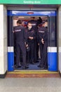 A group of policemen gets into an underground subway car