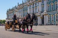 Saint Petersburg, Russia - June 17, 2017: Horse carriage carries tourists on the Palace square along the Hermitage. Royalty Free Stock Photo
