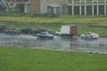 One car drives on a wet road past traffic cars during the rain