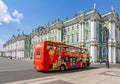 Saint Petersburg, Russia - June 2021: Red sightseeing bus on Palace square with Hermitage museum at background Royalty Free Stock Photo