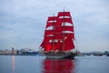 A sailboat with scarlet sails against the background of the arrow of Vasilyevsky Island. `Scarlet Sails`