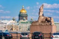 Saint Petersburg, Russia - June 2021: Sphinx statue on University embankment and St. Isaac`s cathedral dome Royalty Free Stock Photo