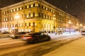 Cars driving on snowy Nevsky Prospect in night