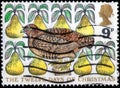 Saint Petersburg, Russia - March 21, 2020: Postage stamp issued in the United Kingdom with the image of the Partridge in a Pear