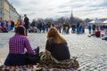 Young people listen to musician on Palace Square, St. Petersburg, Russia