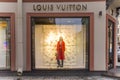 Show window of Louis Vuitton fashion store, decorated in Christmas style with bright Royalty Free Stock Photo