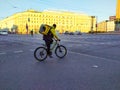 Saint Petersburg, Russia, October 6, 2021, Yandex courier delivers food by bike around the city. A man on a bicycle crosses the