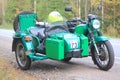 A motorcycle with a sidecar on the road during the closing of the motorcycle season