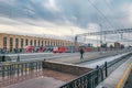 Platform with trains at the Baltic Railway Station in the morning. Passengers walk along the platform