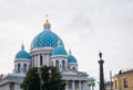 Trinity Cathedral with blue domes and the Column of Glory. The monument was built in 1886 by architect David Grimm.