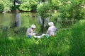 Two adult ladies in white hats had a picnic on the riverbank on the first day of the Park`s