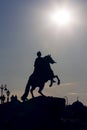 Vertical silhouette of Bronze Horseman sculpture of Peter the Great on blue sky and sunshine background
