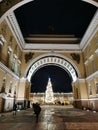 View from under the arch of the General Staff building to the Christmas fir tree on Palace Square, decorated in a retro style with Royalty Free Stock Photo