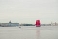 Saint Petersburg,Russia-06.02.2021 : white night,sailing ship with scarlet sails in the midst of Neva river,the dome of St. Isaac` Royalty Free Stock Photo