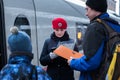 Saint Petersburg, Russia: a woman train conductor in a red beret of a Sapsan express train