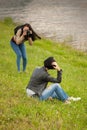 Young woman photographer doing a photoshoot with model outdoors