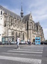 People cross road near cathedral in french town of Saint Quentin