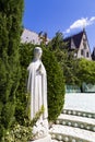 Saint statue and on background the gargoyle that protects the castle