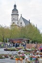 Saint Thomas Church seen from Plants and flowers stalls at Marktplatz, market square in city centre of Leipzig in Germany