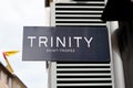 Trinity Saint Tropez sign text and logo brand on facade store wall entrance shop