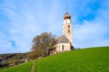 Saint Valentin Church and beautiful morning light at sunrise with green fields. Blue skies, Bolzano, Italy Royalty Free Stock Photo