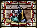 Saint Vincent de Paul helps a prisoner, stained glass window from Saint Germain-l`Auxerrois church in Paris Royalty Free Stock Photo
