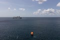 Saint Vincent - May 8, 2020: Aerial shot of an orange lifeboat sailing in the foreground. Carnival Valor, Carnival Fascination