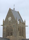 Sainte-Mere-Eglise, FRA, France - August 21, 2022: DDAY Memorial with Paratrooper on bell tower Royalty Free Stock Photo