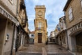 Saintes-Maries-de-la-Mer, France - July 19, 2017: Old town with narrow building of museum Baroncelli topped with sundial