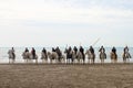 Gardians and Camargue horses on beach by the sea for the procession of an abrivado Royalty Free Stock Photo